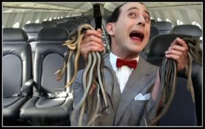 Pee-wee Herman holding 12 snakes on a plane